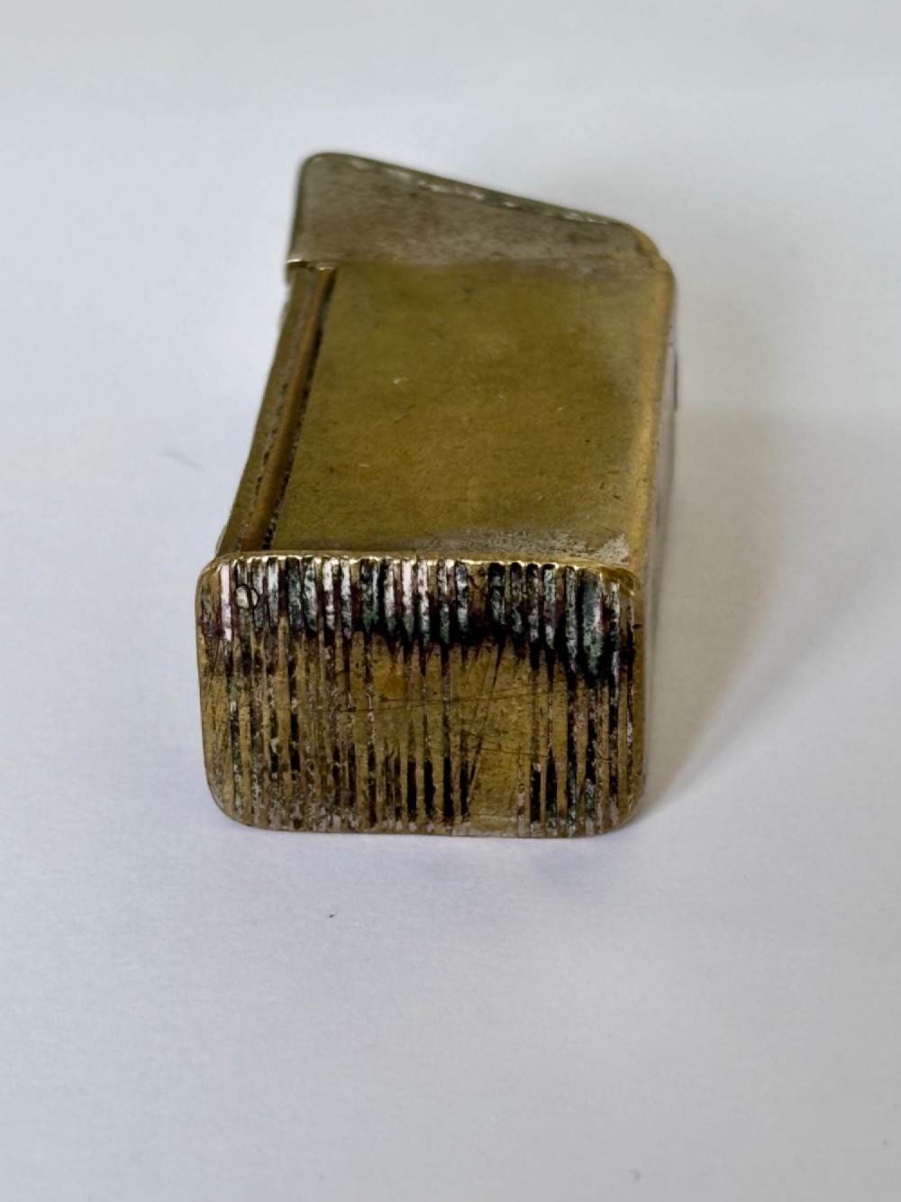 An antique Victorian brass novelty vesta case designed as an outhouse with an opening door revealing a gentleman seated inside. View III