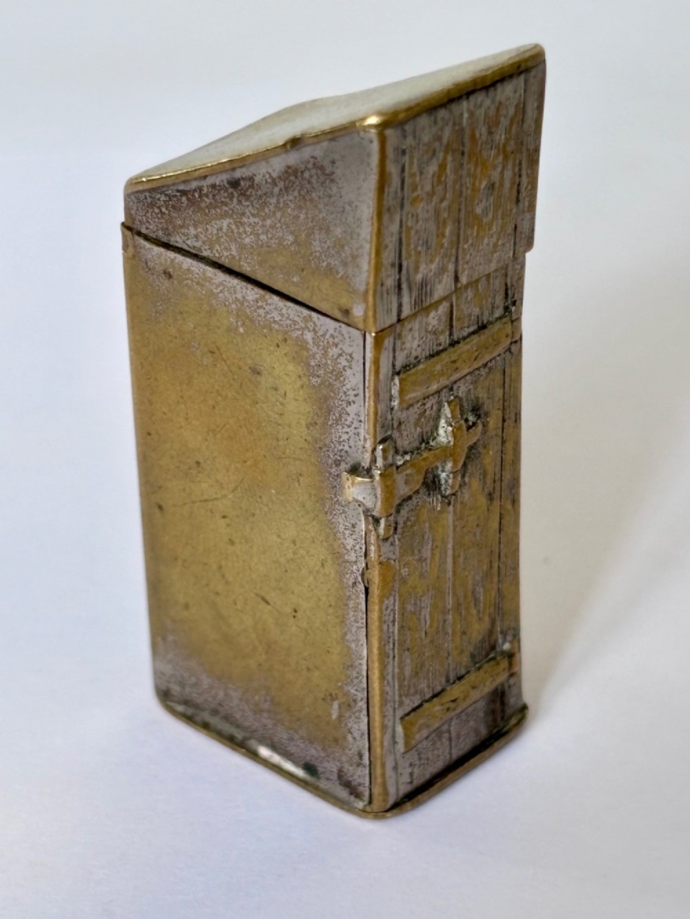 An antique Victorian brass novelty vesta case designed as an outhouse with an opening door revealing a gentleman seated inside. View IV