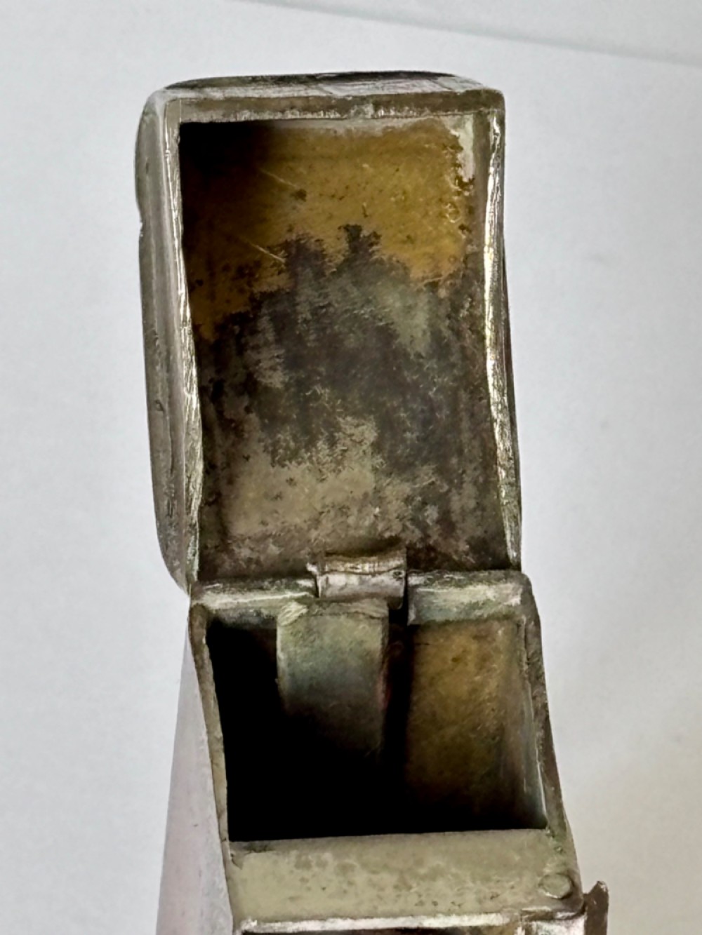 An antique Victorian brass novelty vesta case designed as an outhouse with an opening door revealing a gentleman seated inside. View VII