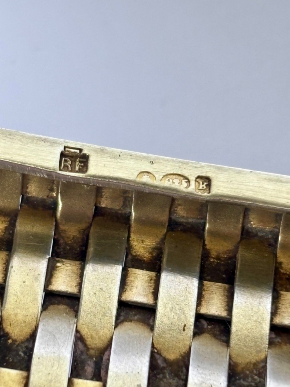 An early 20th-century rectangular silver cigarette case with a textured basketweave pattern and a side release button. View VIII