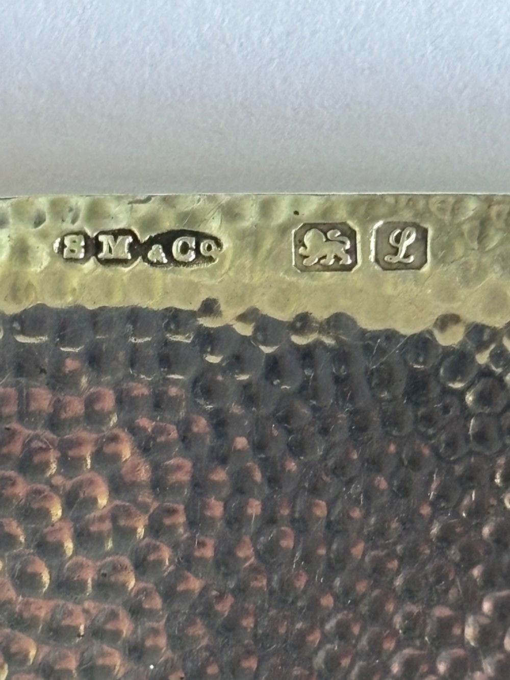A slimline rectangular sterling silver card case featuring a hand-hammered planished surface texture. View II