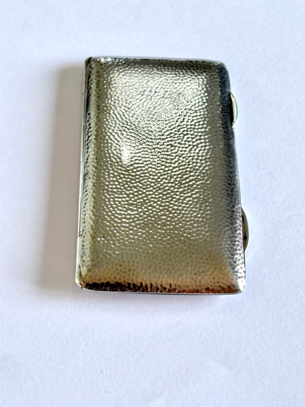 A slimline rectangular sterling silver card case featuring a hand-hammered planished surface texture. View III
