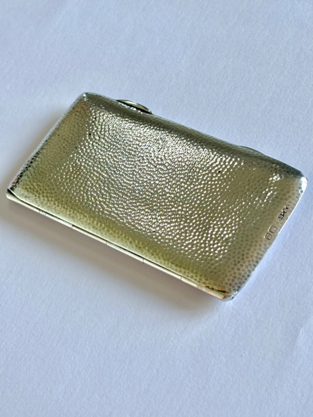 A slimline rectangular sterling silver card case featuring a hand-hammered planished surface texture. View IV