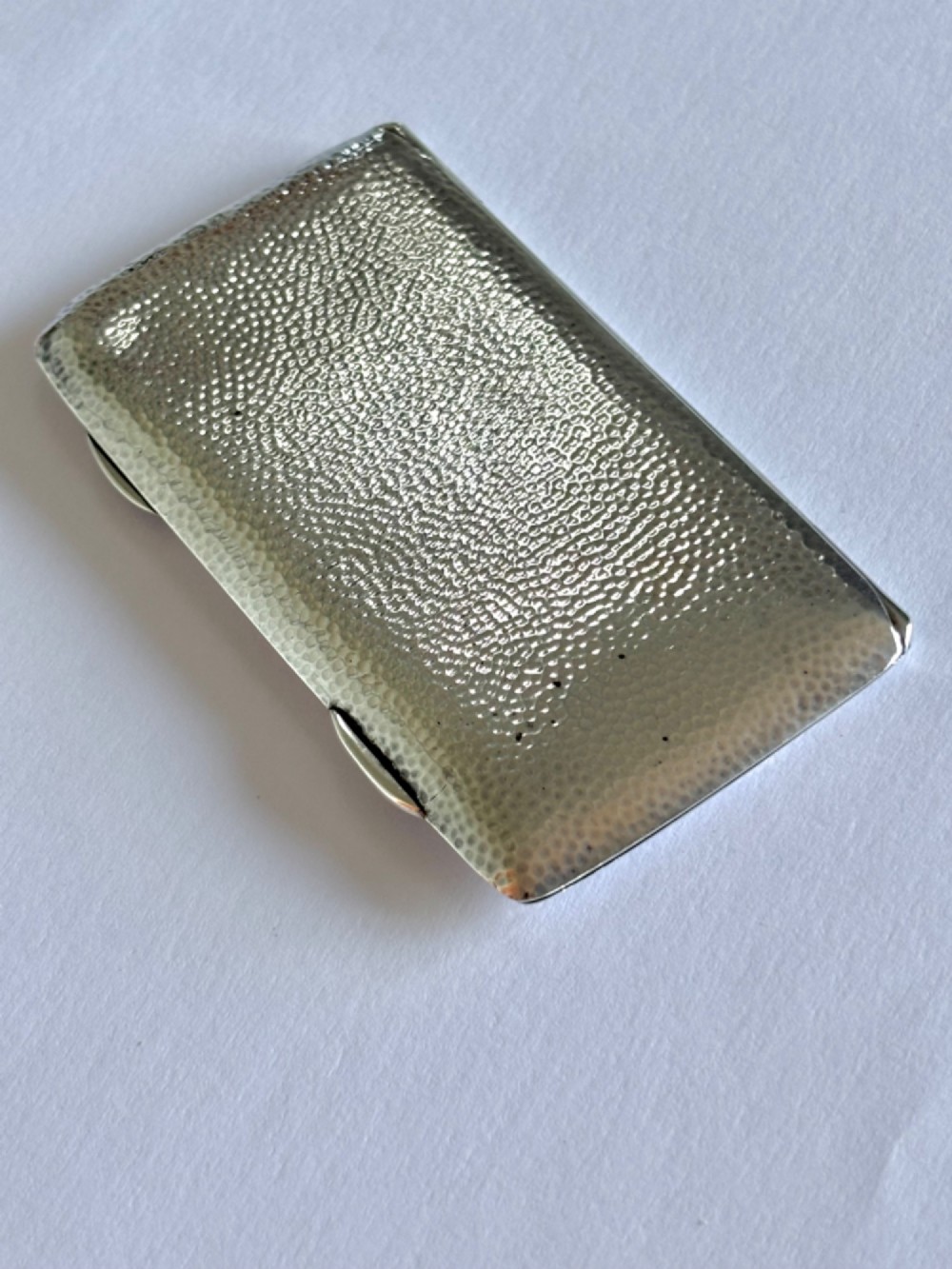 A slimline rectangular sterling silver card case featuring a hand-hammered planished surface texture. View V