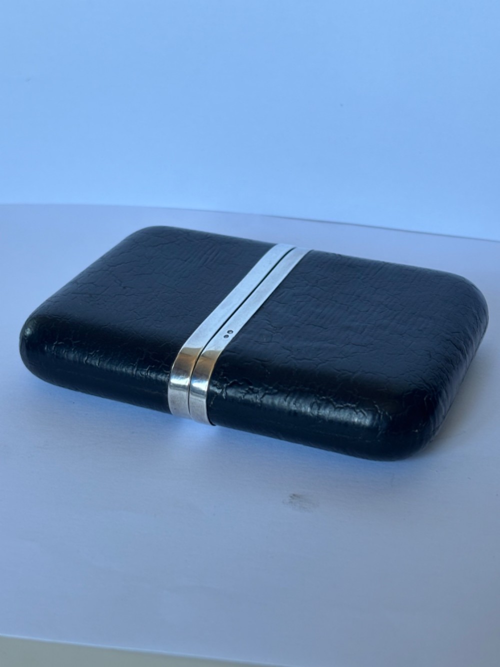 An antique black textured leather cigar case featuring a central hallmarked 900 silver collar. View IV