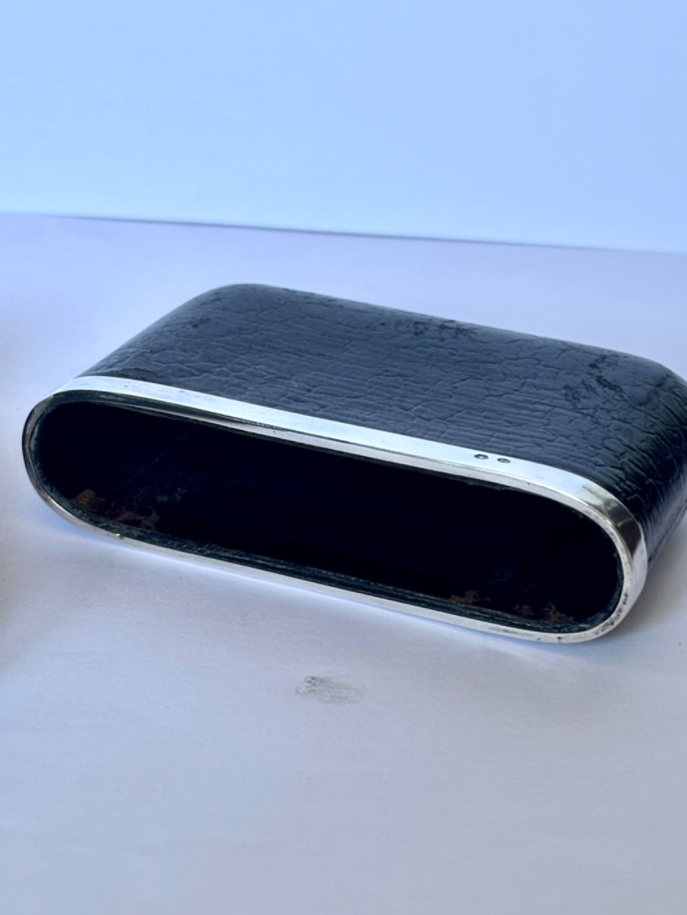 An antique black textured leather cigar case featuring a central hallmarked 900 silver collar. View X