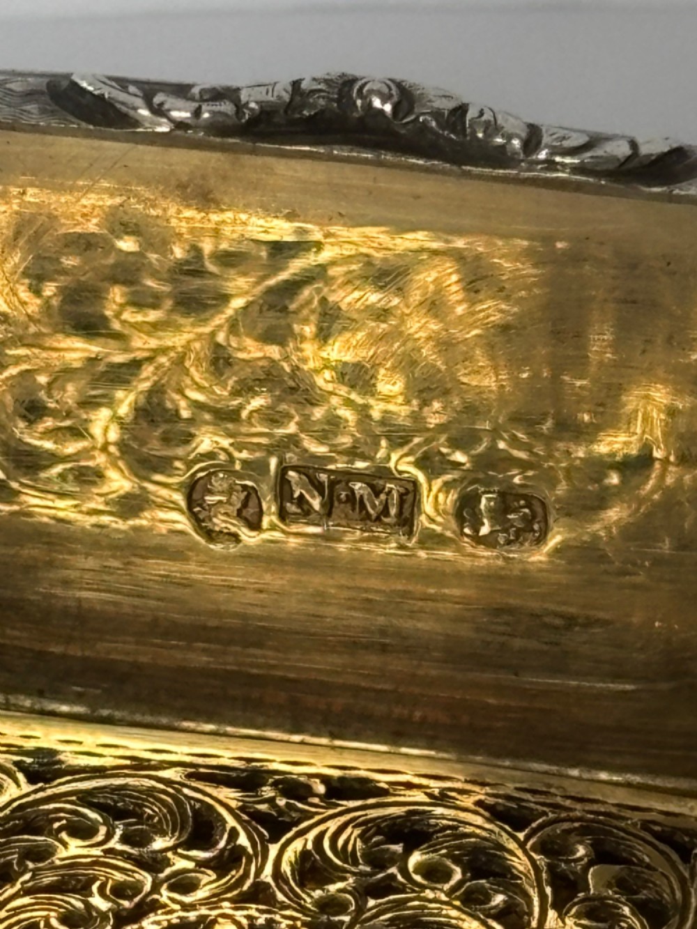 A small open rectangular silver-gilt box featuring a finely pierced floral inner grille and engraved lid detailing. View III