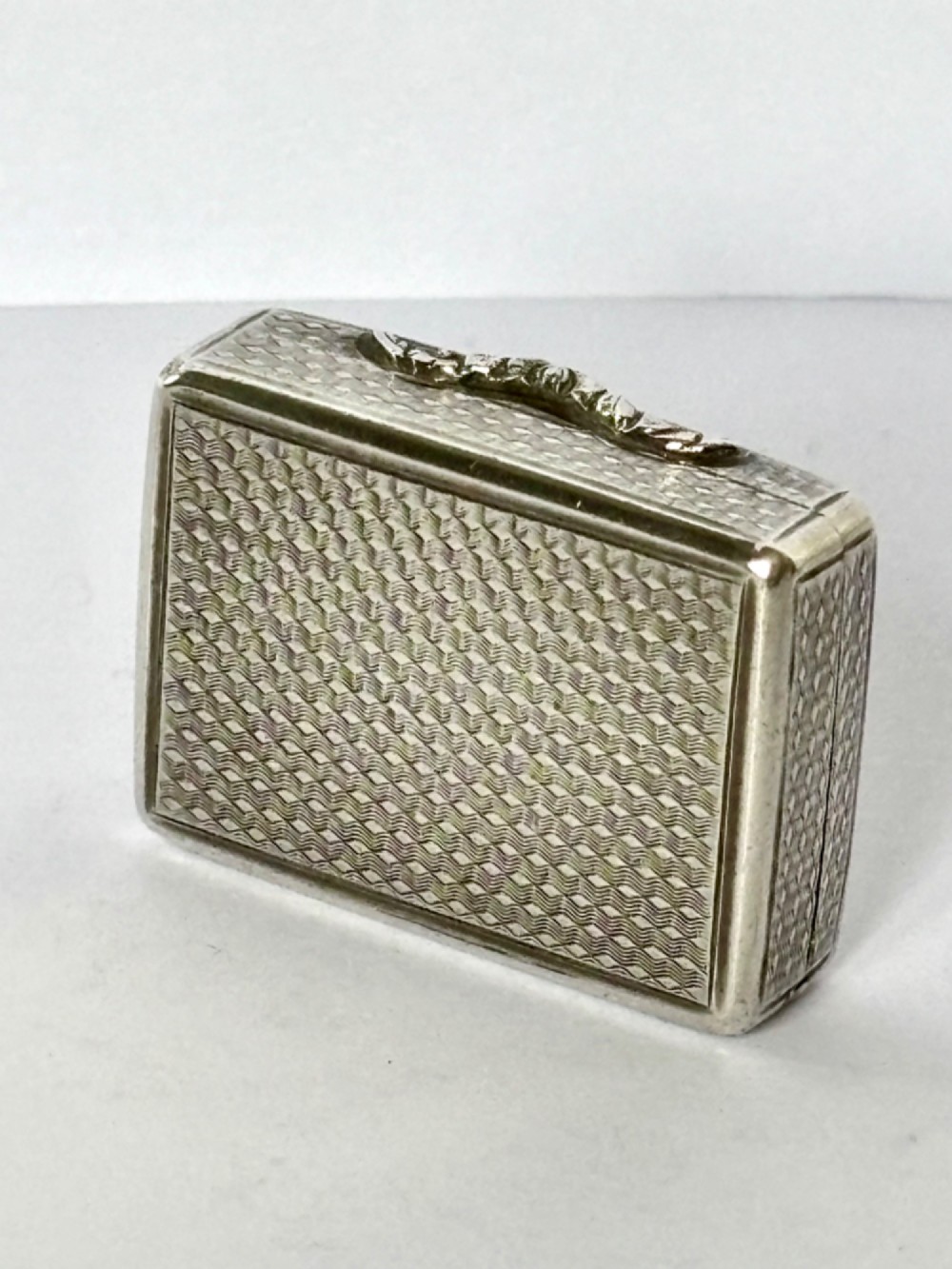 A small open rectangular silver-gilt box featuring a finely pierced floral inner grille and engraved lid detailing. View VI