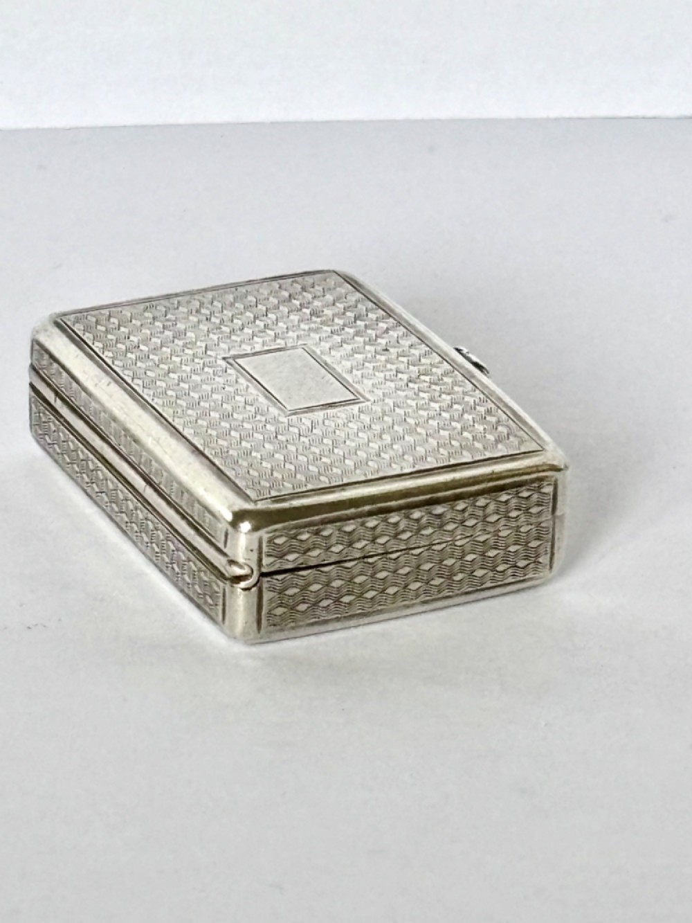 A small open rectangular silver-gilt box featuring a finely pierced floral inner grille and engraved lid detailing. View VIII