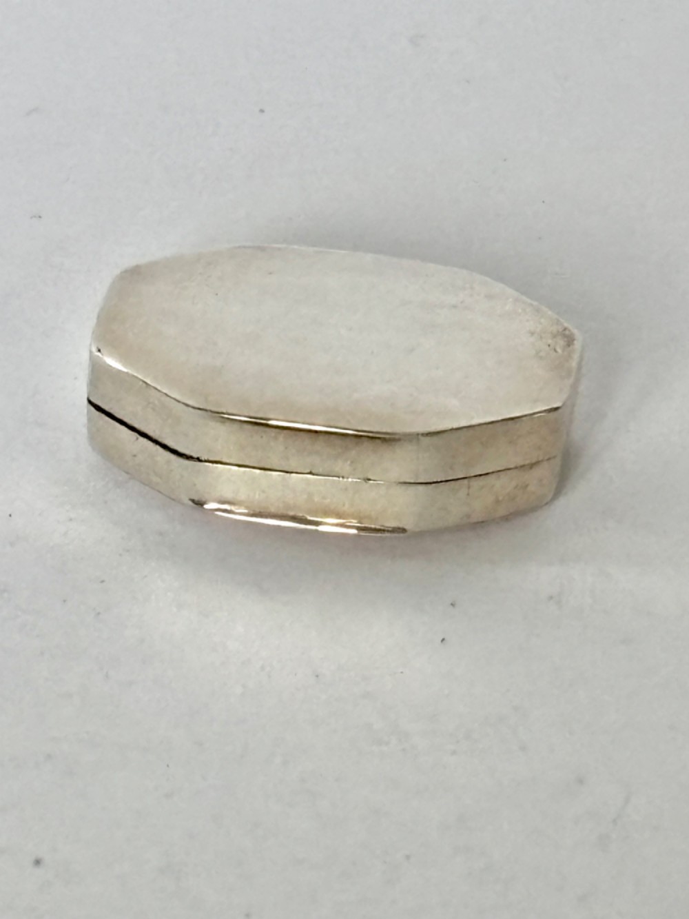 An open George III octagonal sterling silver vinaigrette displaying a gilded interior with a perforated cover and makers stamp. View IV