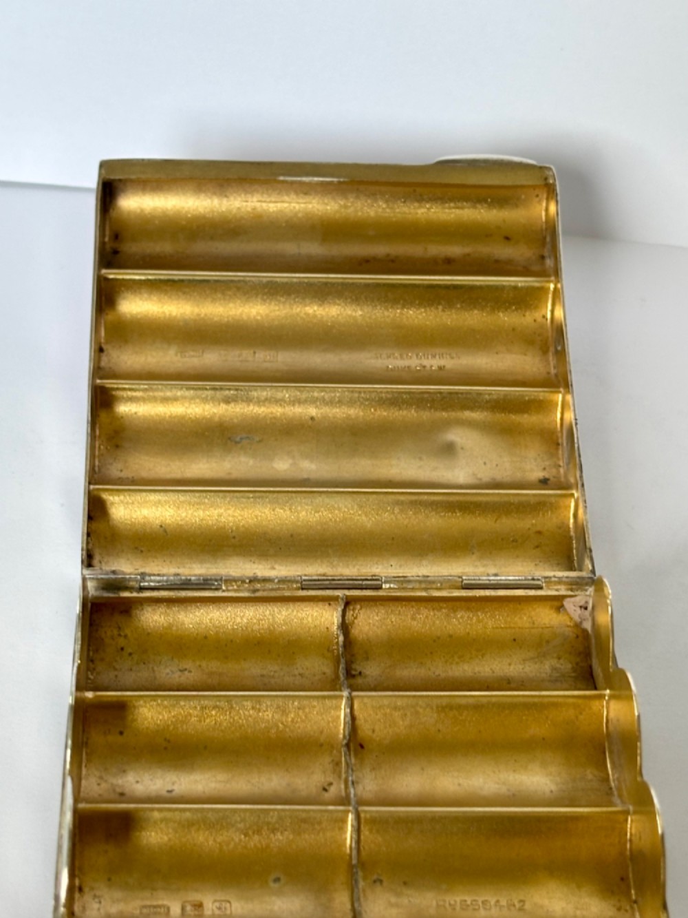 A four-tube sterling silver tobacco cartridge case with a hinged cover and smooth polished finish. View VIII