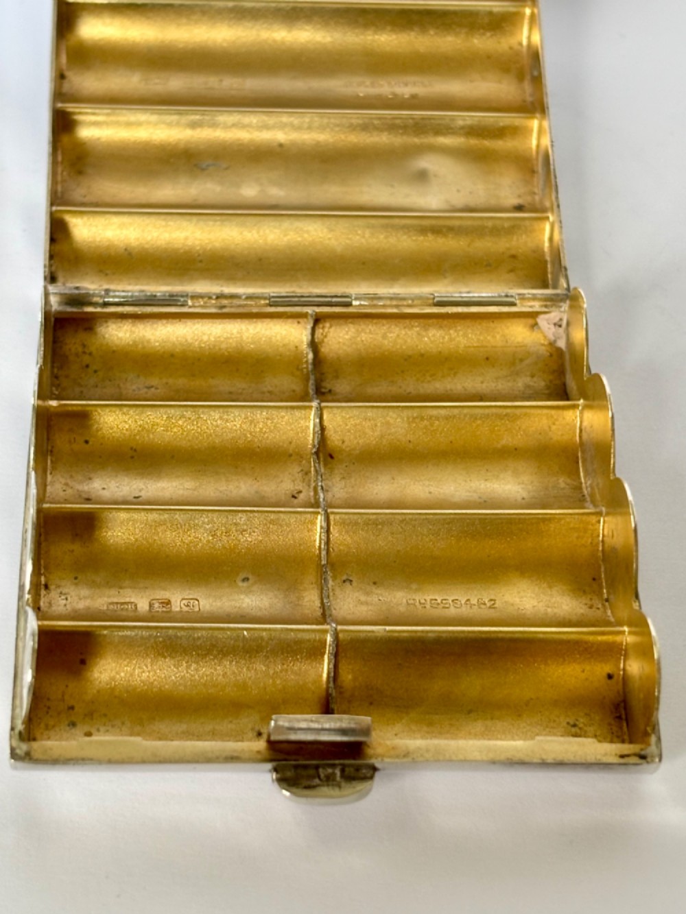 A four-tube sterling silver tobacco cartridge case with a hinged cover and smooth polished finish. View IX