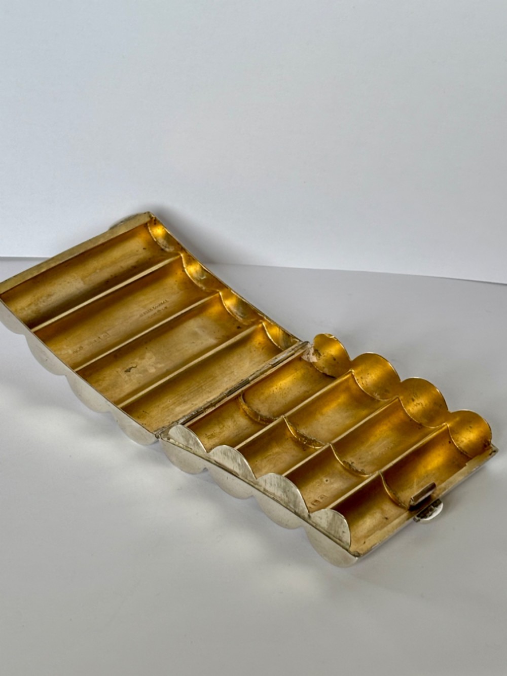 A four-tube sterling silver tobacco cartridge case with a hinged cover and smooth polished finish. View X