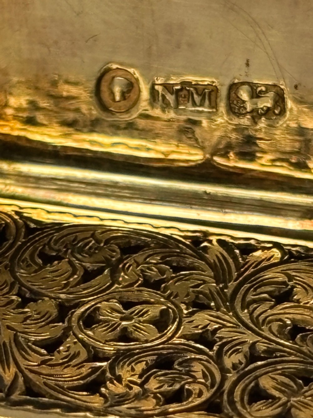 An open Early Victorian silver gilt vinaigrette showing a floral pierced interior grille and hallmarks on the inside lid. View II