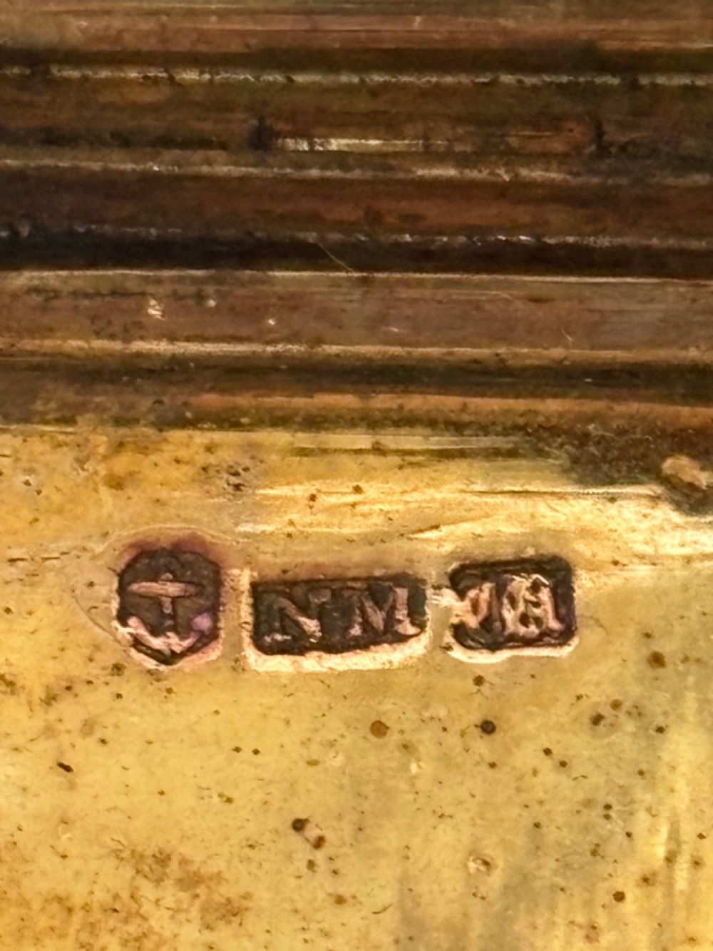 An open Early Victorian silver gilt vinaigrette showing a floral pierced interior grille and hallmarks on the inside lid. View X