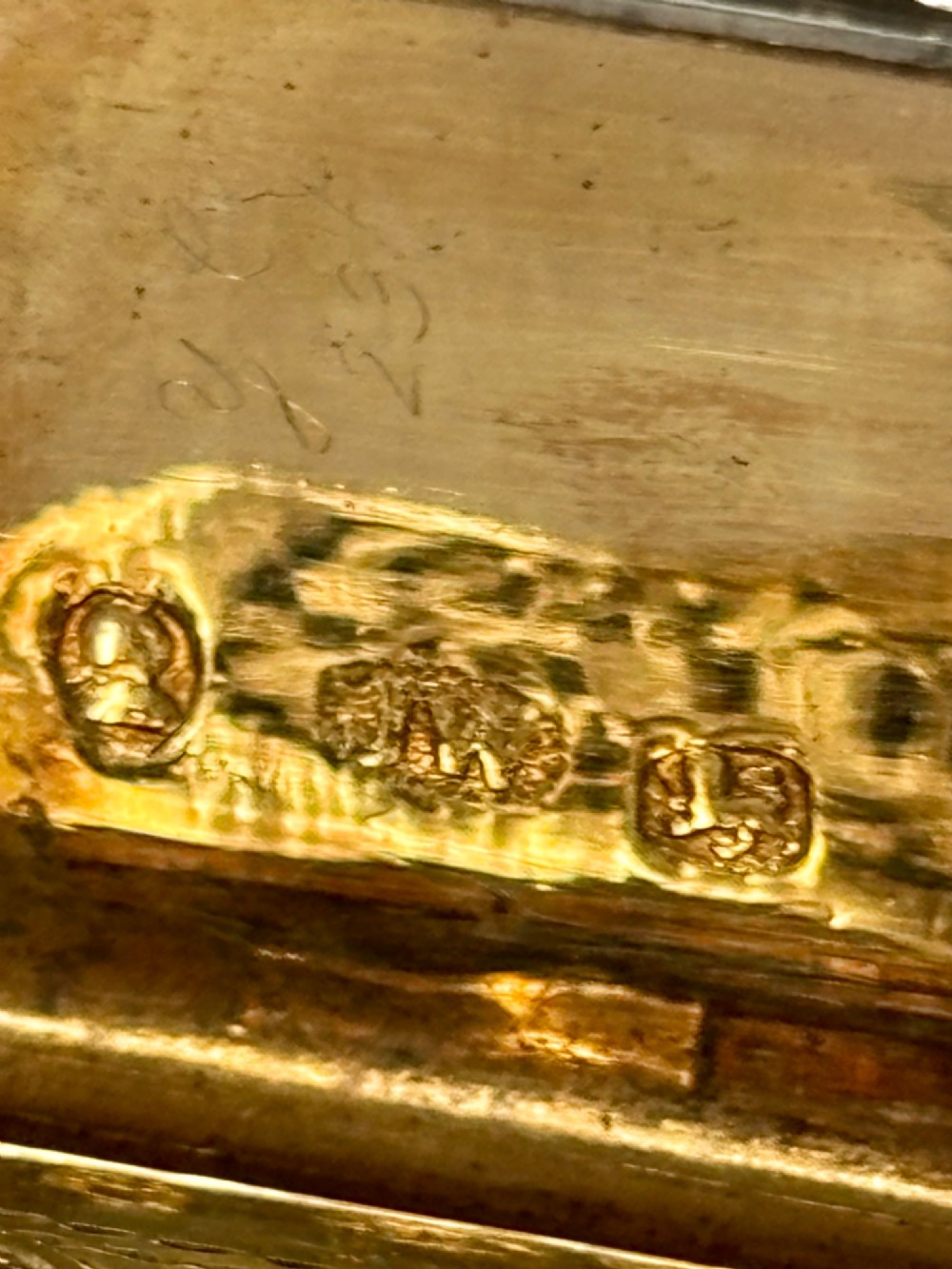 An open George IV rectangular silver-gilt vinaigrette showing internal hallmarks and a hinged pierced grille next to a small dark sponge. View VIII