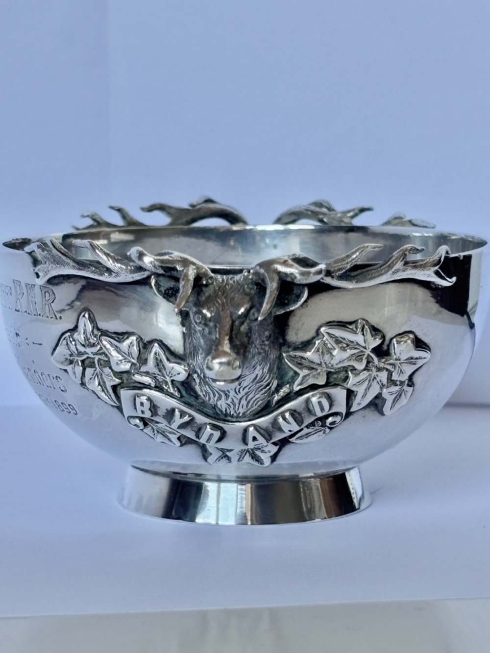 Late Victorian Scottish silver quaich featuring cast stag head handles and an engraved military presentation inscription on a circular pedestal base. View II