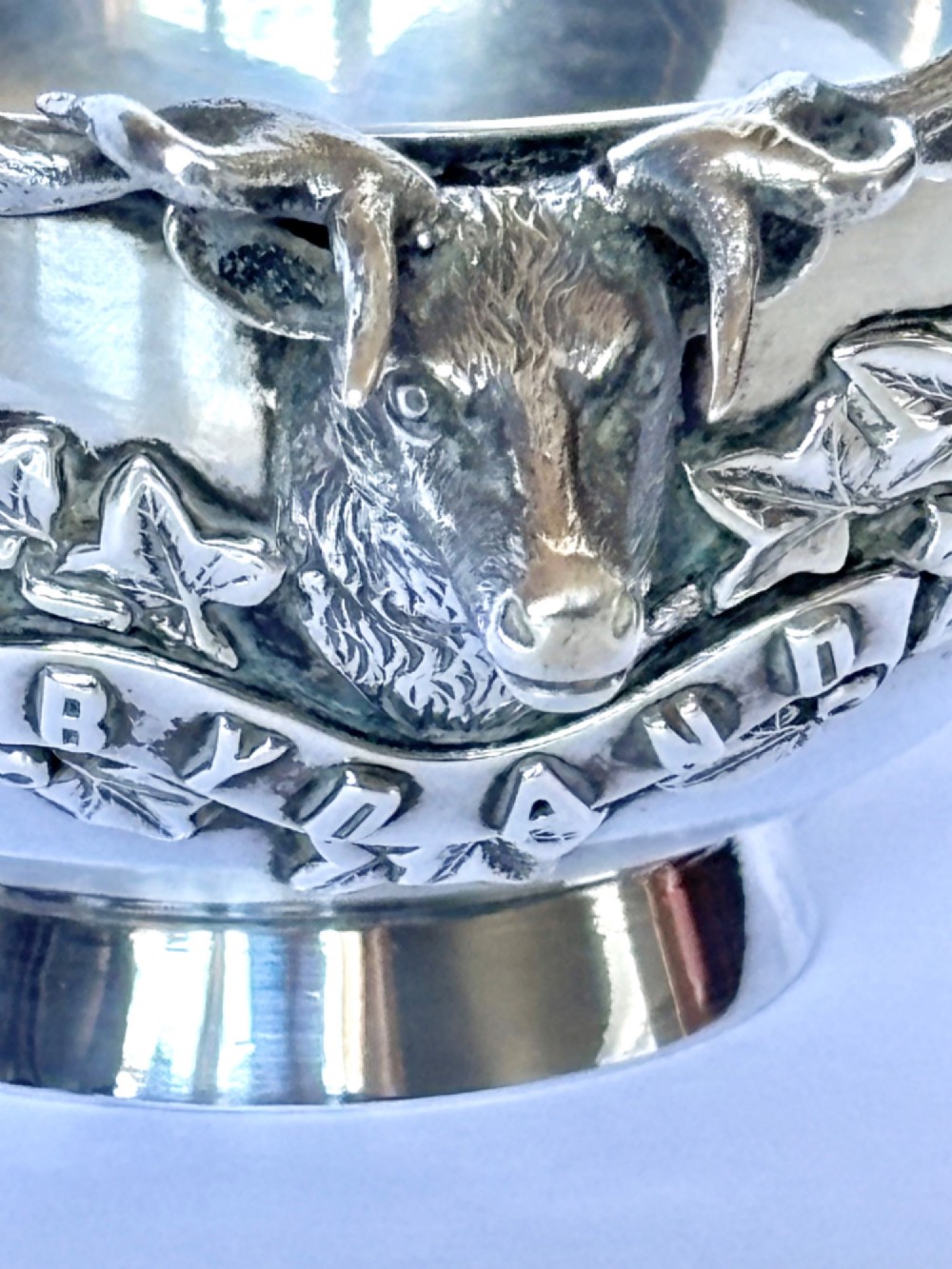 Late Victorian Scottish silver quaich featuring cast stag head handles and an engraved military presentation inscription on a circular pedestal base. View III