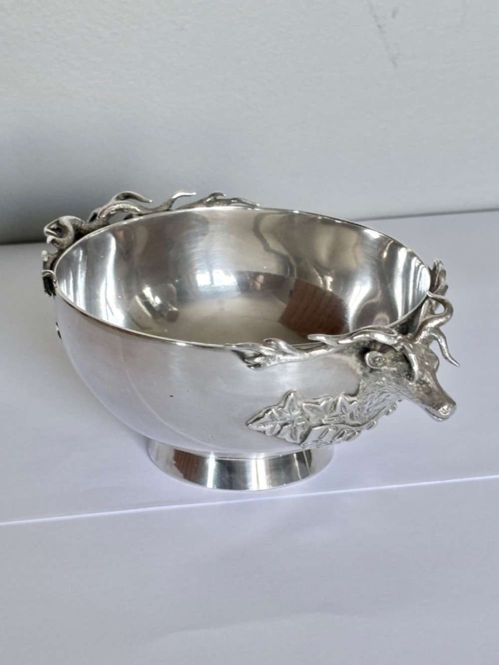Late Victorian Scottish silver quaich featuring cast stag head handles and an engraved military presentation inscription on a circular pedestal base. View VII