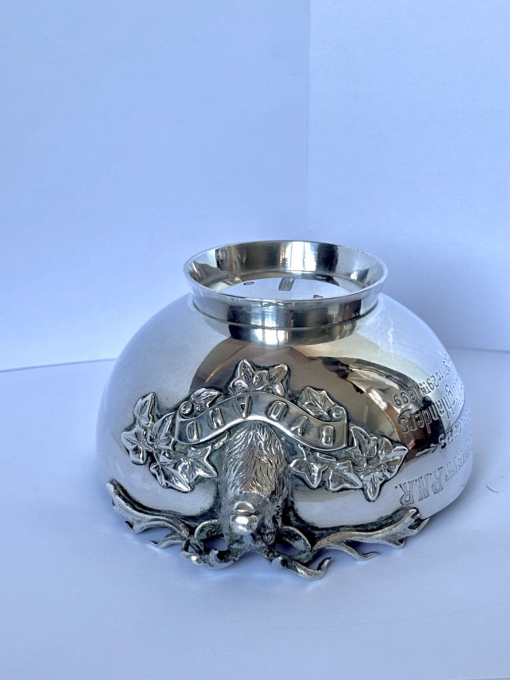 Late Victorian Scottish silver quaich featuring cast stag head handles and an engraved military presentation inscription on a circular pedestal base. View X