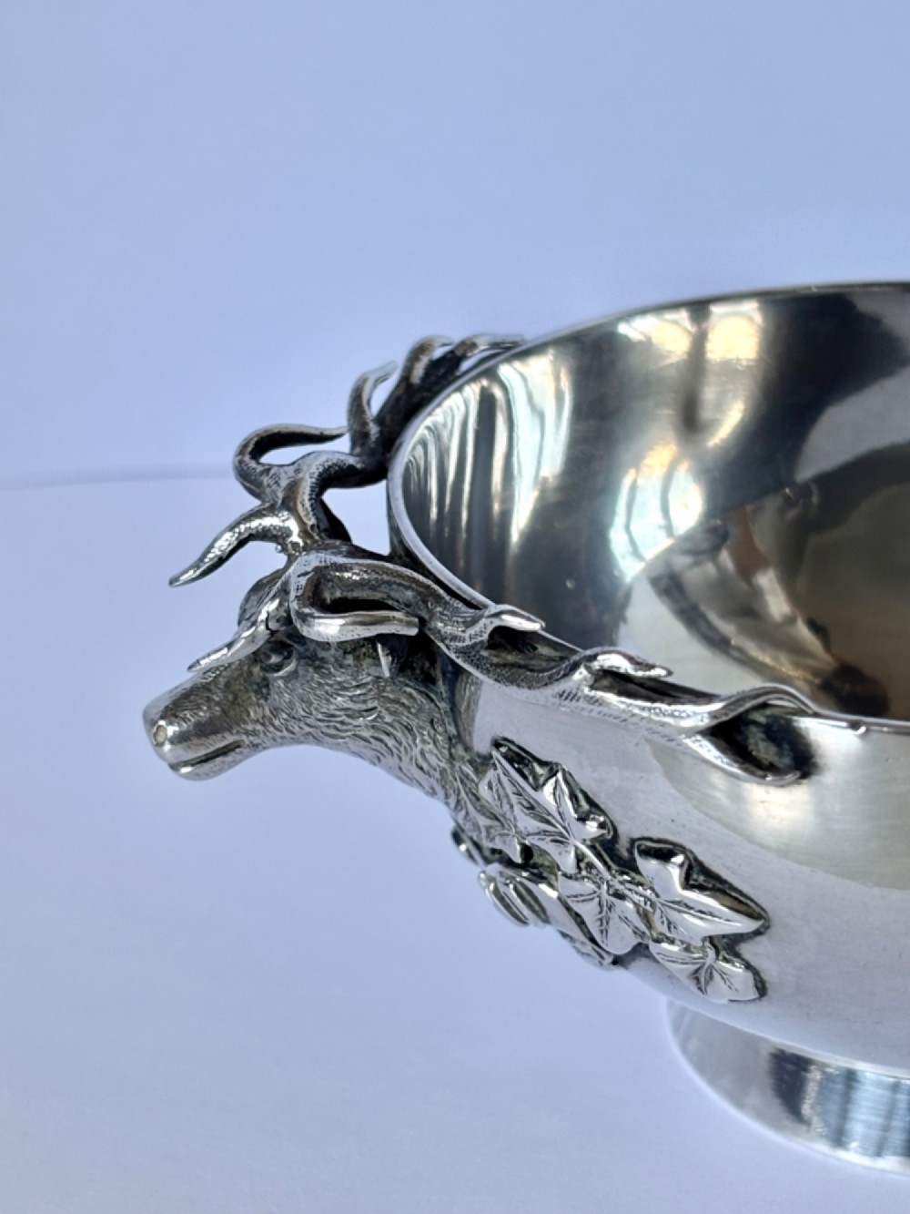 Late Victorian Scottish silver quaich featuring cast stag head handles and an engraved military presentation inscription on a circular pedestal base. View XI