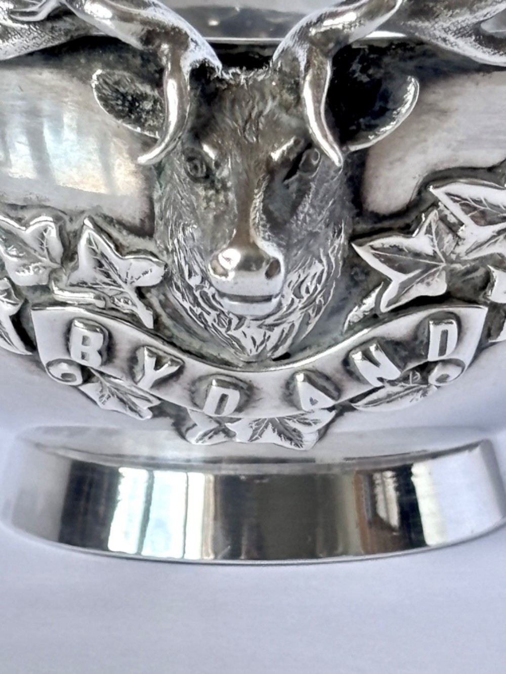 Late Victorian Scottish silver quaich featuring cast stag head handles and an engraved military presentation inscription on a circular pedestal base. View XII