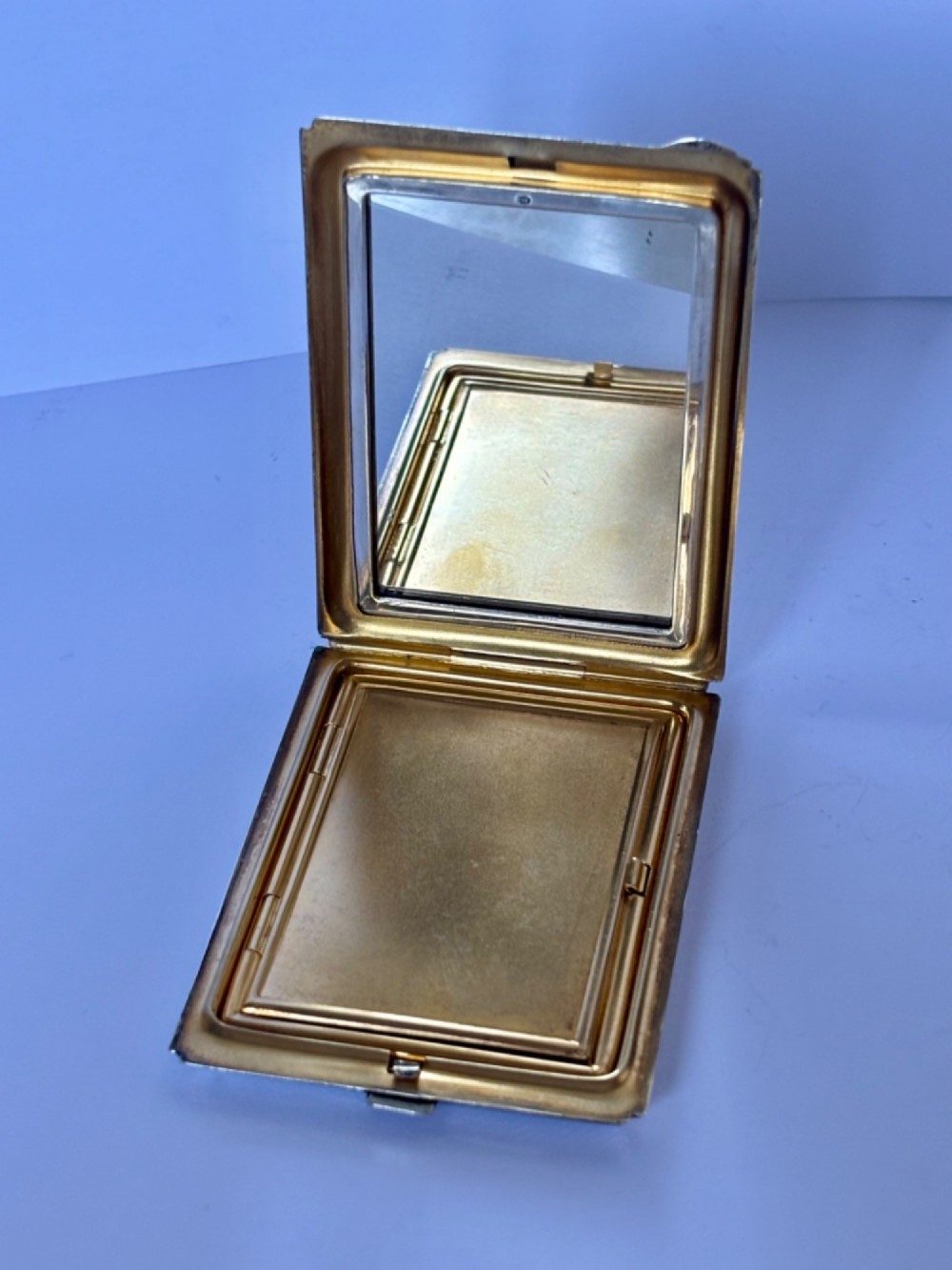A square sterling silver Art Deco powder compact featuring linear engine-turned patterns and a central geometric stepped motif. View VI