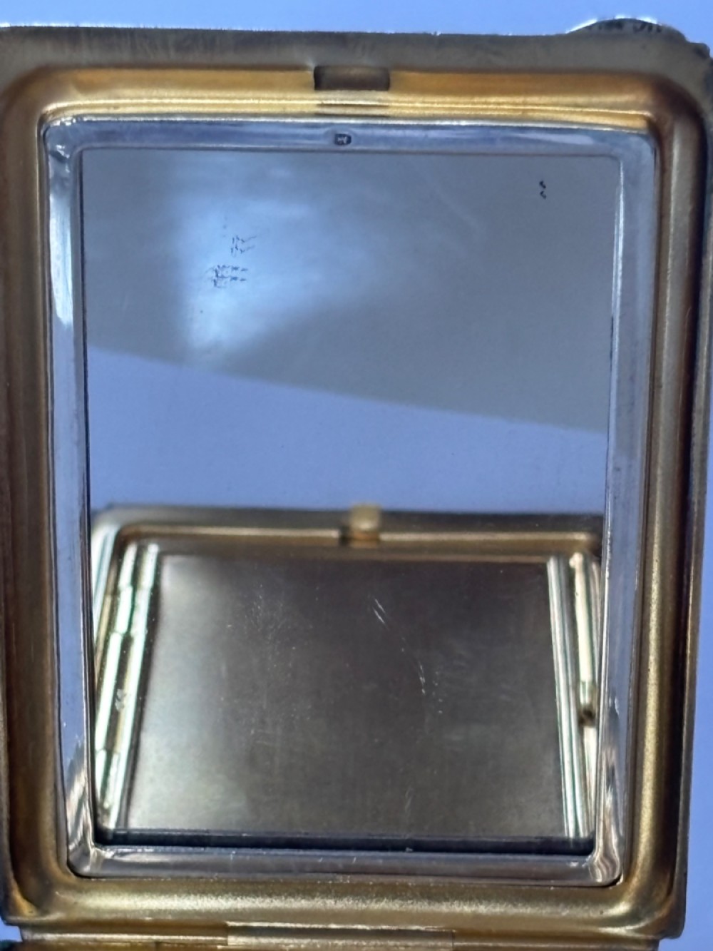 A square sterling silver Art Deco powder compact featuring linear engine-turned patterns and a central geometric stepped motif. View VII