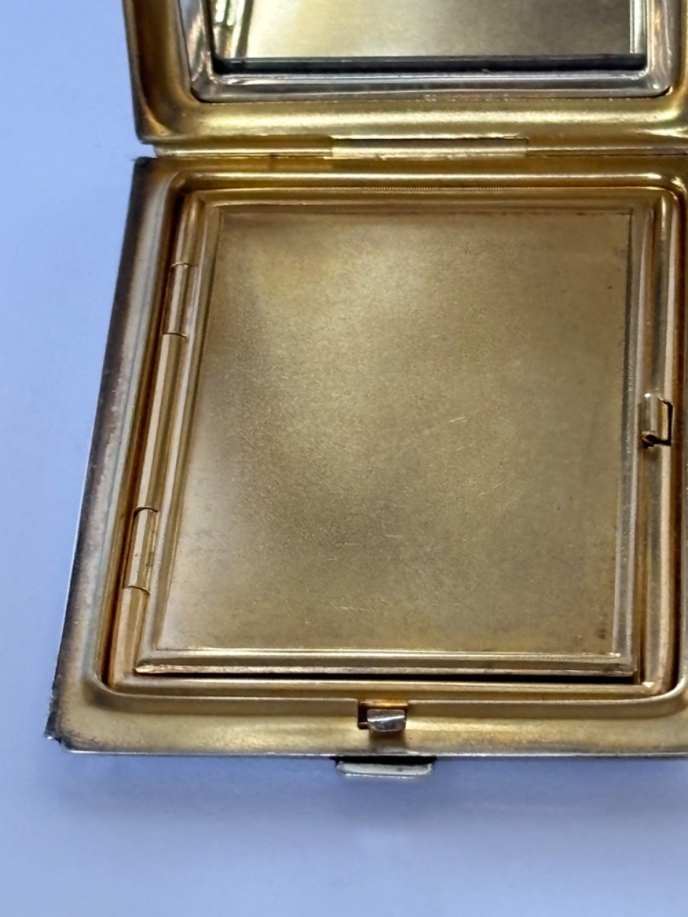 A square sterling silver Art Deco powder compact featuring linear engine-turned patterns and a central geometric stepped motif. View VIII
