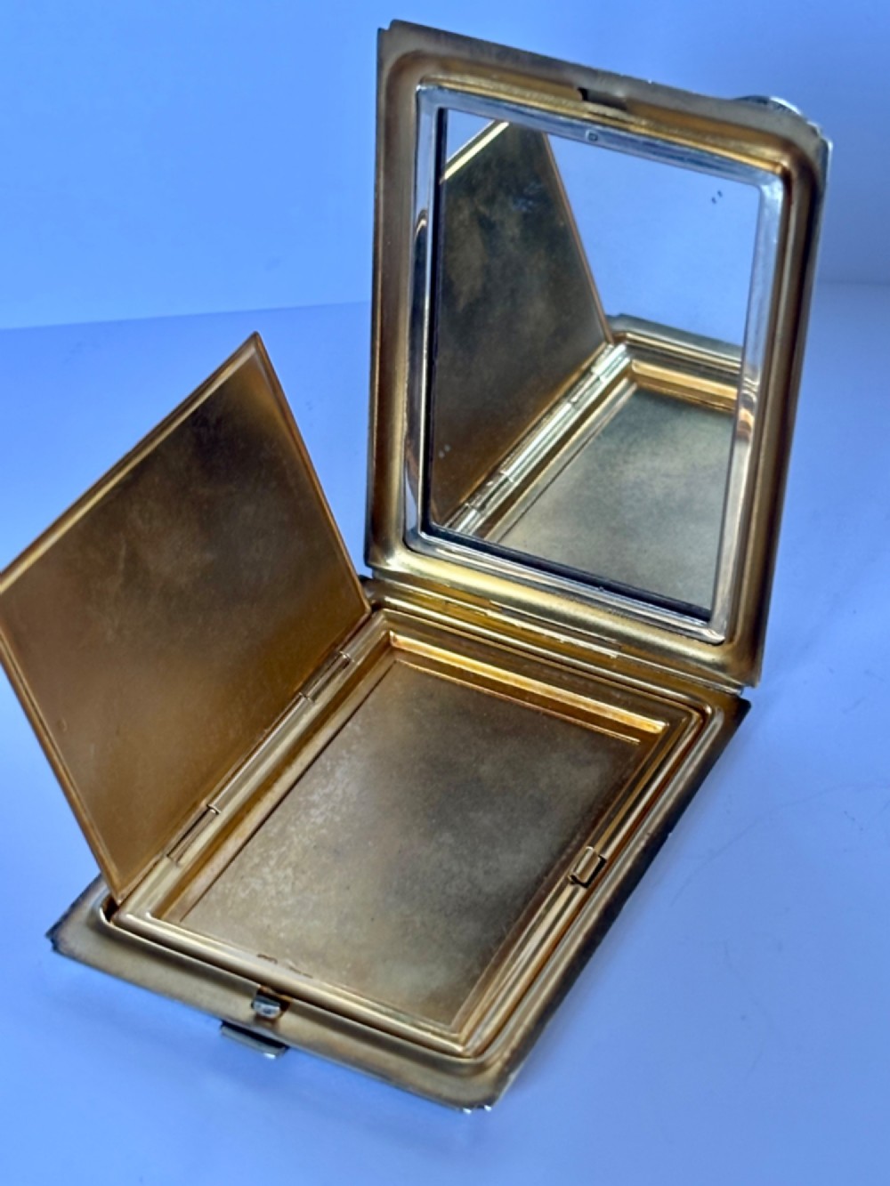 A square sterling silver Art Deco powder compact featuring linear engine-turned patterns and a central geometric stepped motif. View IX