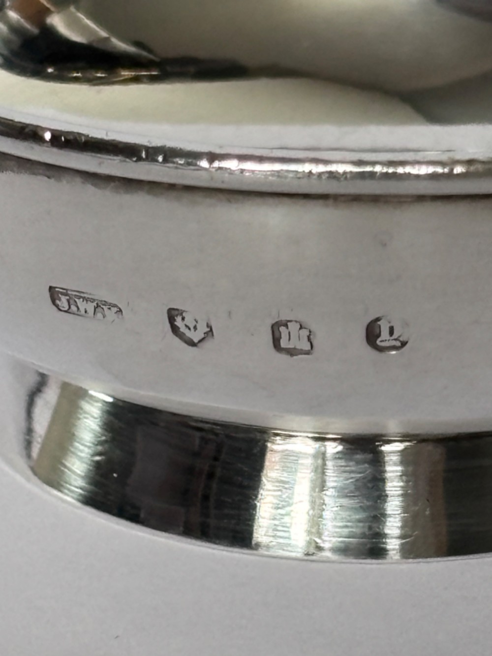 A shallow sterling silver Scottish quaich featuring two flat lug handles and engraved Gaelic lettering in the centre bowl. View IV