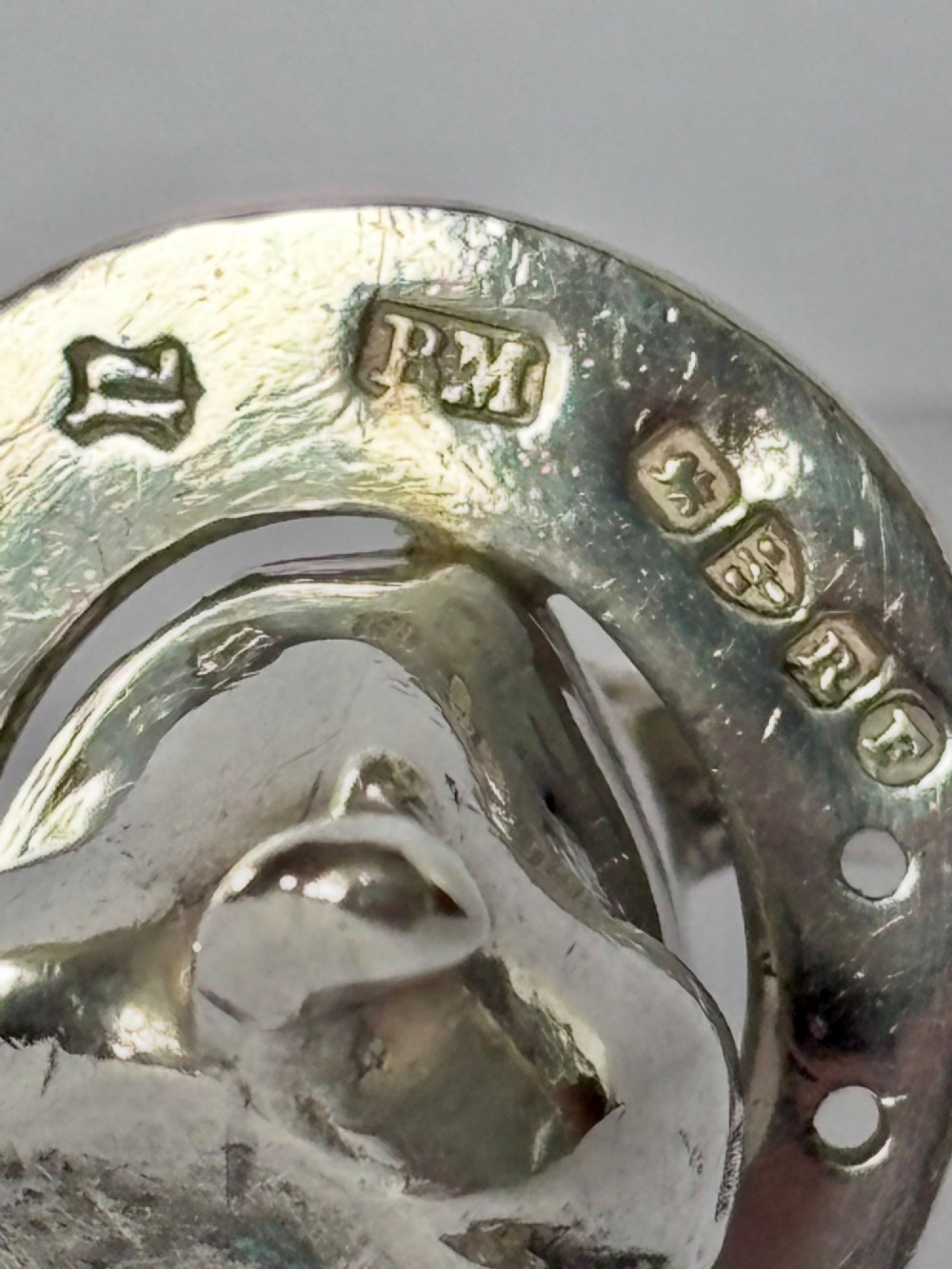 A Victorian sterling silver novelty figurine depicting a pig framed inside a horseshoe. View IV