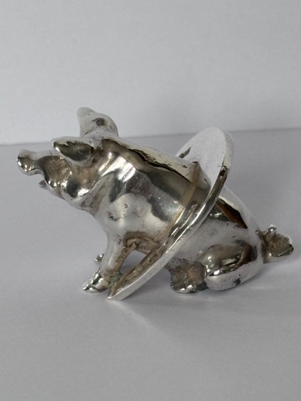 A Victorian sterling silver novelty figurine depicting a pig framed inside a horseshoe. View VII