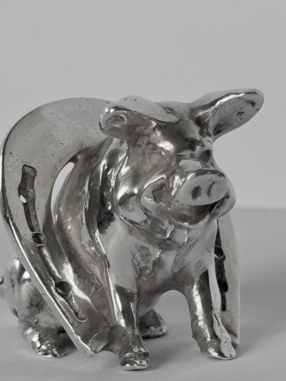 A Victorian sterling silver novelty figurine depicting a pig framed inside a horseshoe. View VIII