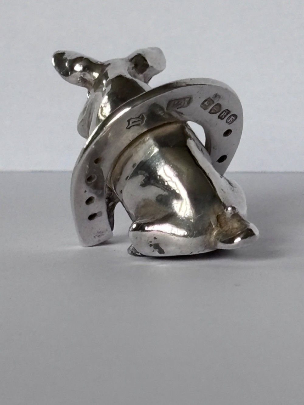 A Victorian sterling silver novelty figurine depicting a pig framed inside a horseshoe. View XI
