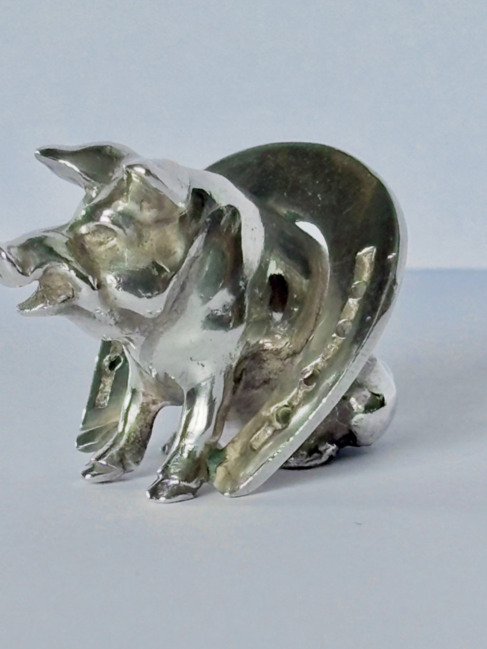 A Victorian sterling silver novelty figurine depicting a pig framed inside a horseshoe. View XII