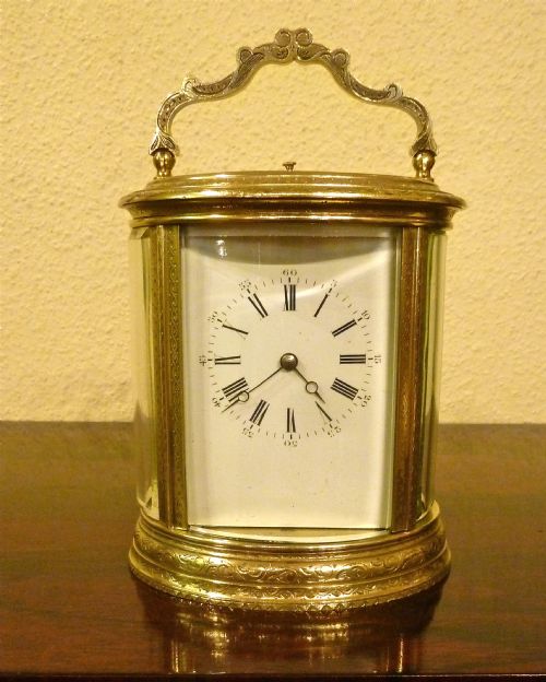 A Very Fine French Engraved Oval Carriage Clock