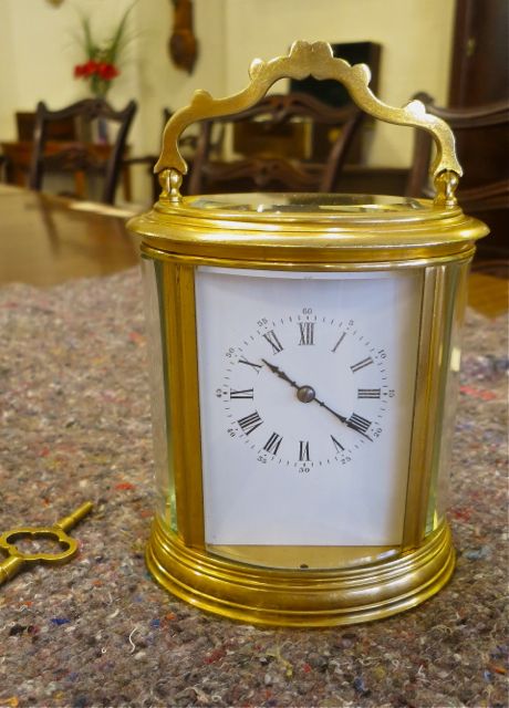 A Good French Oval Striking Carriage Clock