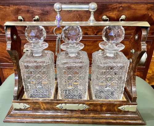 A Polished Dark Honey-oak Cased Three-bottle Tantalus