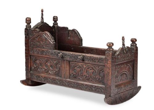 fig 1. FINE CARVED OAK CRADLE DATED 1677