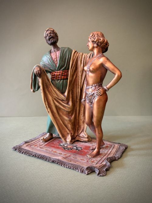 fig 1. An Austrian cold-painted bronze figure group depicting a draped Orientalist figure standing beside a female figure on a patterned carpet base.