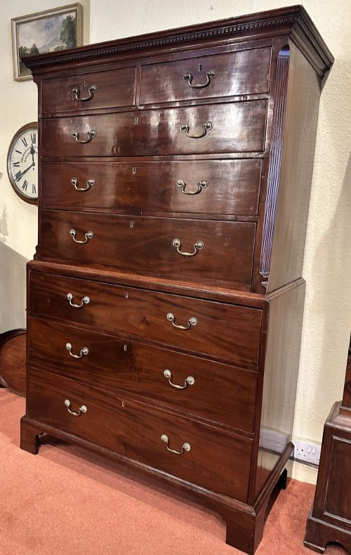 fig 1. A tall George III mahogany chest-on-chest featuring two upper short drawers over three long drawers, resting on a base section with three further long drawers and bracket feet.