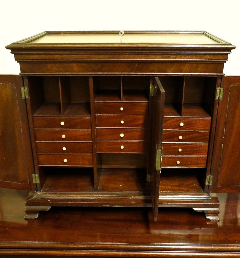 AN INTRIGUING MAHOGANY TABLE CABINET