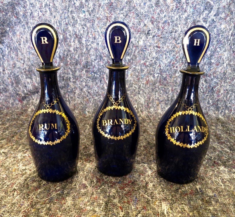 SET OF THREE BRISTOL BLUE-GLASS DECANTERS