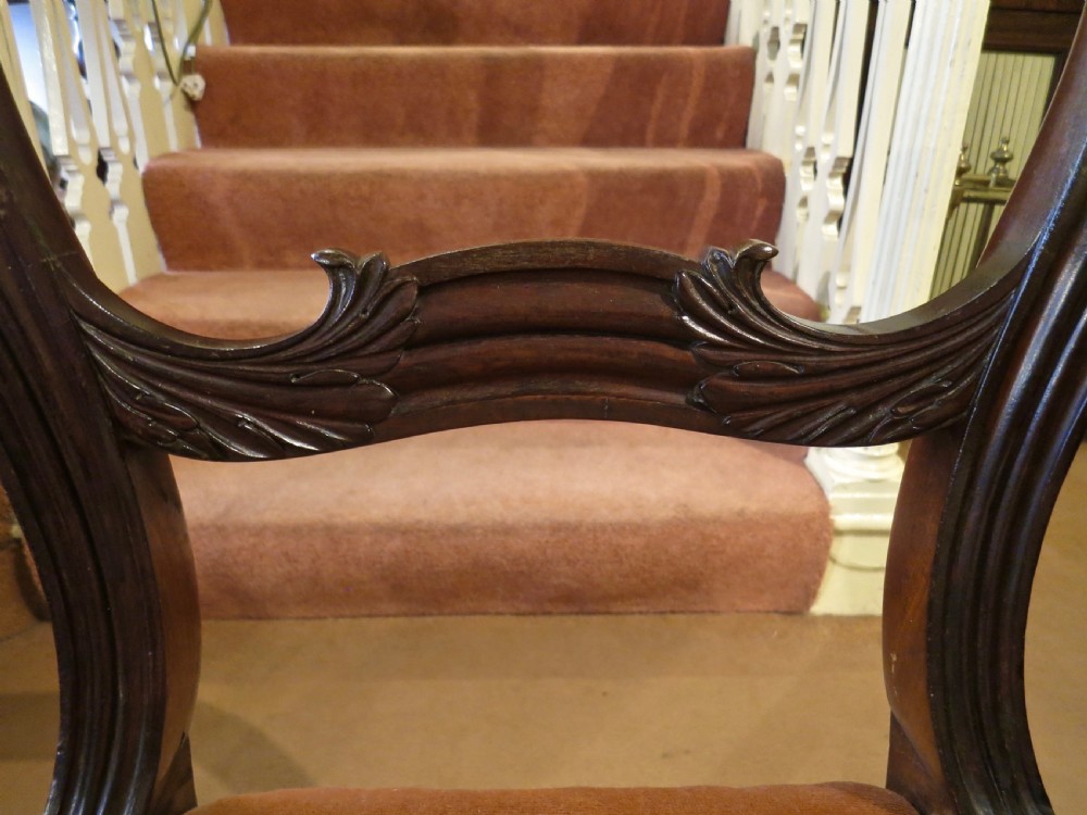A pair of carved mahogany balloon-back dining chairs with brown velvet upholstered seats and fluted turned legs. View IV