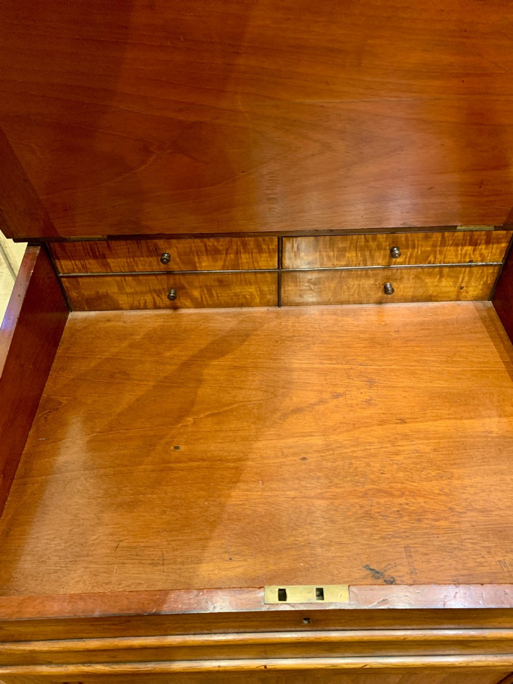An antique rosewood Davenport desk featuring a sloped leather writing surface, top brass gallery, and side drawers with turned wooden knobs. View II