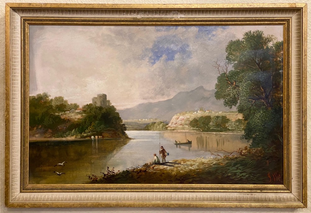 A framed 19th-century oil painting on canvas depicting a tranquil river landscape with figures on the bank and a distant hill topped with castle ruins.
