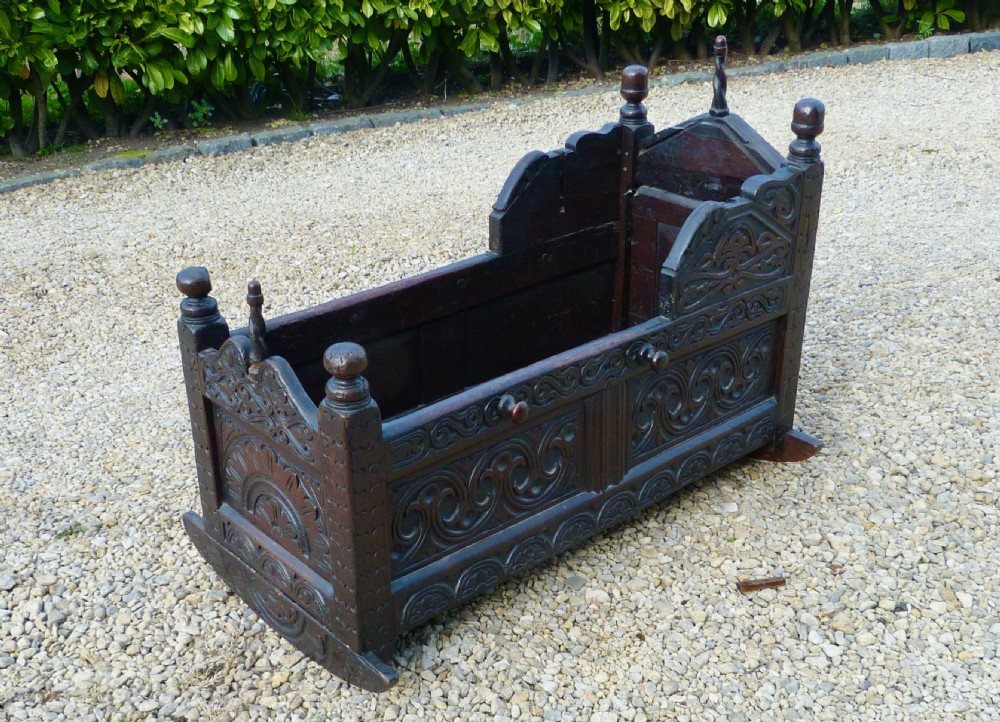 FINE CARVED OAK CRADLE DATED 1677 View III