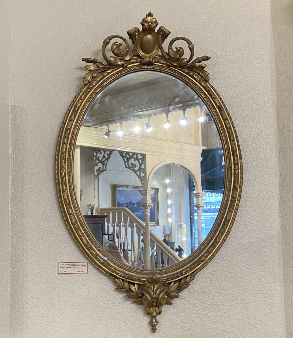 Victorian ornately framed oval mirror