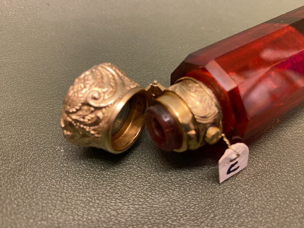 A Ruby glass DOUBLE-ENDED Scent Bottle with embossed gilt metal tops View III